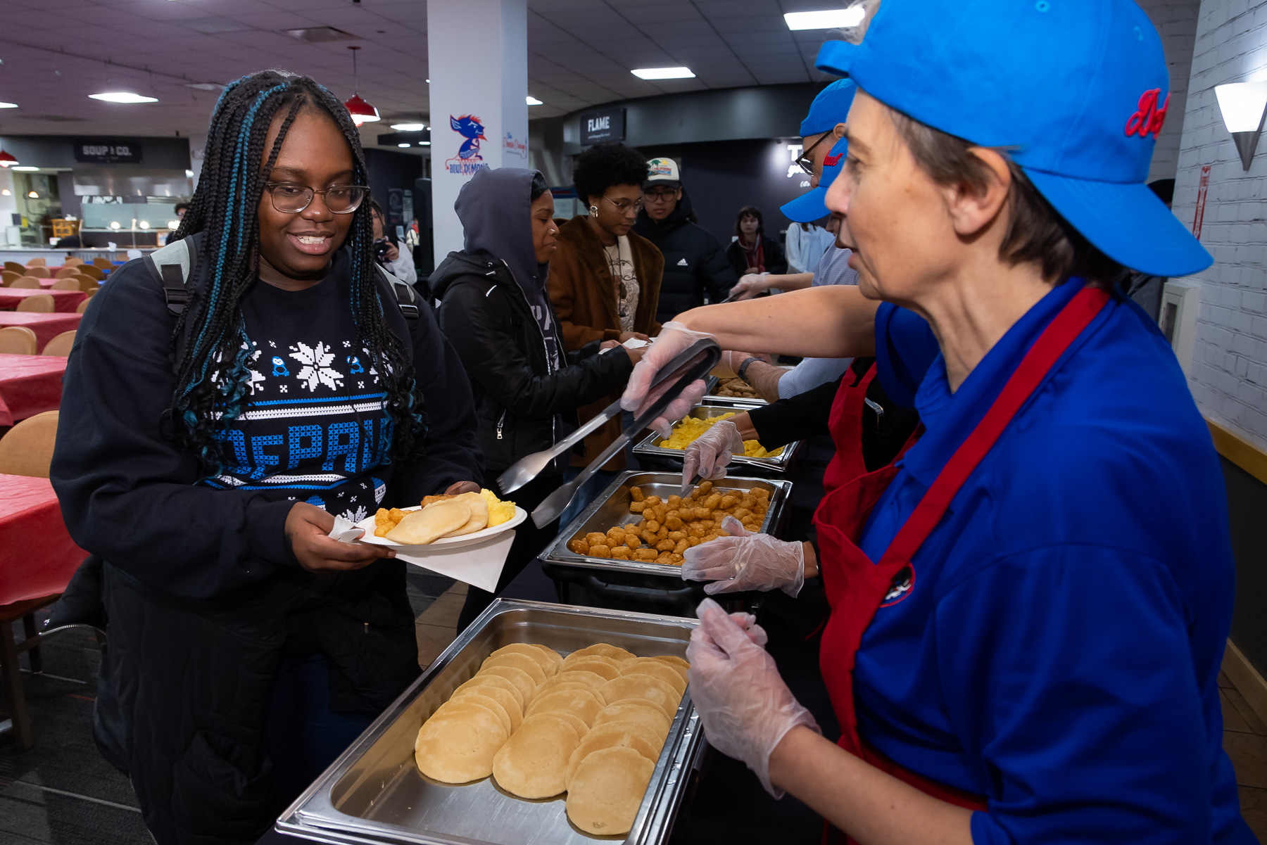 Faculty and staff volunteers dished out a late night breakfast to more than 2000 students in the first hour of the holiday favorite event. (Photo by Jeff Carrion / DePaul University) 